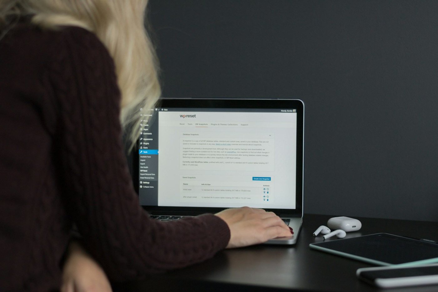 Designer working at a laptop on brand layouts