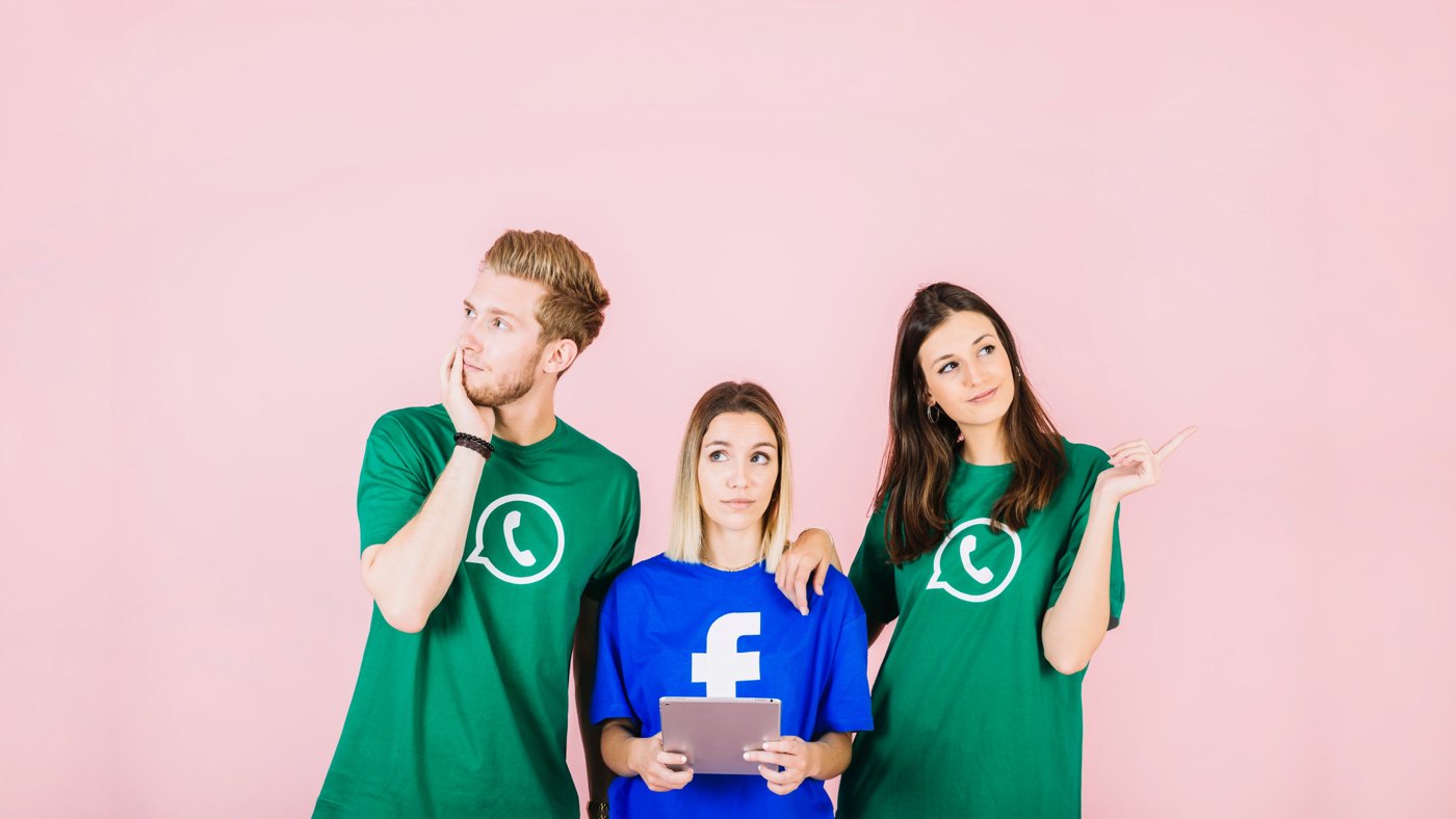 Team wearing social media branded t-shirts holding a tablet