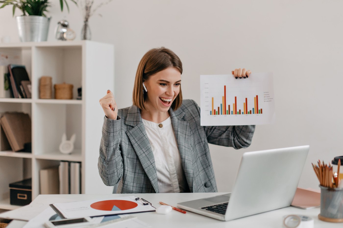 Business owner reviewing website performance charts on a laptop